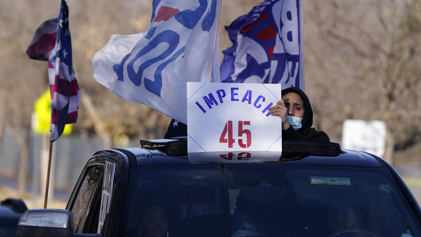 <p>Ein Mann hält ein Plakat hoch, das die Amtsenthebung von Präsident Donald Trump fordert.</p>
